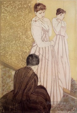 María Cassatt Painting - Mujer joven probándose un vestido madres hijos Mary Cassatt